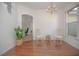 Dining area with hardwood floors, chandelier, and two chairs at 5649 Magnolia Bloom Ter, Oviedo, FL 32765