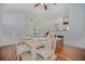 Dining area with hardwood floors, table, chairs, and access to the kitchen at 5649 Magnolia Bloom Ter, Oviedo, FL 32765