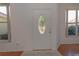 Front entry with white door, glass accents, and hardwood floors at 5649 Magnolia Bloom Ter, Oviedo, FL 32765