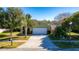 House exterior featuring a green facade and a white garage door at 5649 Magnolia Bloom Ter, Oviedo, FL 32765