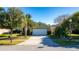 House exterior showcasing a green facade and a driveway at 5649 Magnolia Bloom Ter, Oviedo, FL 32765