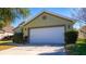 Exterior of house with green walls and white garage door at 5649 Magnolia Bloom Ter, Oviedo, FL 32765