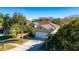Single story house, green exterior, two car garage, landscaping at 5649 Magnolia Bloom Ter, Oviedo, FL 32765