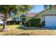 House exterior with green walls, arched entry, and landscaped yard at 5649 Magnolia Bloom Ter, Oviedo, FL 32765