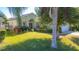 Well-maintained house with a green exterior, lush landscaping, and a two-car garage at 5649 Magnolia Bloom Ter, Oviedo, FL 32765