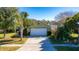 Aerial view of a house with a green exterior, landscaping, and a driveway at 5649 Magnolia Bloom Ter, Oviedo, FL 32765