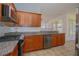 Bright kitchen featuring granite countertops and stainless steel appliances at 5649 Magnolia Bloom Ter, Oviedo, FL 32765