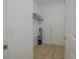 Small laundry room with tile floor, shelving, and vacuum at 5649 Magnolia Bloom Ter, Oviedo, FL 32765