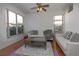 Living room with hardwood floors, neutral walls, and comfy seating at 5649 Magnolia Bloom Ter, Oviedo, FL 32765