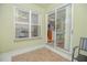 Bright enclosed porch with view of the kitchen and backyard at 5649 Magnolia Bloom Ter, Oviedo, FL 32765