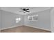 Spacious bedroom with ceiling fan, wood flooring, and a large window at 609 Aldama Ct, Ocoee, FL 34761