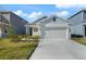 Two-story home with gray siding, attached garage, and landscaped yard at 640 Reggie Rd, Winter Haven, FL 33884