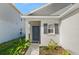Front entrance with gray door, shutters, and walkway at 640 Reggie Rd, Winter Haven, FL 33884