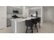 Modern kitchen featuring gray cabinets, a large island, and stainless steel appliances at 640 Reggie Rd, Winter Haven, FL 33884