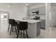 Modern kitchen with gray cabinets, stainless steel appliances and an island with seating at 640 Reggie Rd, Winter Haven, FL 33884