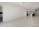 Open living room with tile floors and access to the kitchen and bedroom at 640 Reggie Rd, Winter Haven, FL 33884