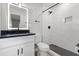 Updated bathroom boasts a sleek vanity, modern lighting, and a stylish tiled shower with black fixtures at 718 N Grandview Ave, Daytona Beach, FL 32118
