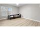 Bright bedroom with wood-look flooring, and a large window allowing lots of natural light to come in at 718 N Grandview Ave, Daytona Beach, FL 32118