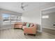 Bright living room showcasing modern wood floors, a ceiling fan, and lots of natural light from the large window at 718 N Grandview Ave, Daytona Beach, FL 32118
