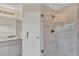 Modern bathroom with a glass-enclosed shower, updated fixtures, and a marble vanity at 7760 Windbreak Rd, Orlando, FL 32819