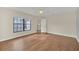A well-lit bedroom with hardwood floors and a ceiling fan with large window overlooking community at 7760 Windbreak Rd, Orlando, FL 32819
