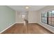 Comfortable bedroom boasting hardwood floors, large window, and neutral color palette at 7760 Windbreak Rd, Orlando, FL 32819