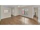 Bright, open room features hardwood floors and a large window allowing for plenty of natural light at 7760 Windbreak Rd, Orlando, FL 32819