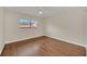 A well-lit room featuring hardwood floors and a ceiling fan and window overlooking community at 7760 Windbreak Rd, Orlando, FL 32819