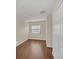 Well-lit bedroom featuring hardwood floors, closet, and windows allowing for natural light at 7760 Windbreak Rd, Orlando, FL 32819