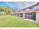 Townhome featuring a private screened lanai and expansive lawn at 7760 Windbreak Rd, Orlando, FL 32819