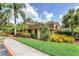 Landscaped grounds with tropical plants and building at 7760 Windbreak Rd, Orlando, FL 32819
