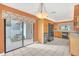 Bright eat-in kitchen boasting tile floors, wooden cabinets, and a view to a private patio at 7760 Windbreak Rd, Orlando, FL 32819