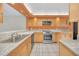 Updated kitchen with granite countertops, stainless steel appliances, and ample cabinet space at 7760 Windbreak Rd, Orlando, FL 32819