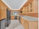 Open-concept kitchen featuring sleek appliances, granite counters, and ample storage at 7760 Windbreak Rd, Orlando, FL 32819