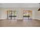 Spacious living room with sliding glass doors to an enclosed lanai with backyard views at 7760 Windbreak Rd, Orlando, FL 32819