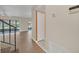 An open-concept living area with wood floors, a staircase, and views to the lanai at 7760 Windbreak Rd, Orlando, FL 32819
