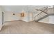 Large living area with wood-look flooring and staircase with metal handrail at 7760 Windbreak Rd, Orlando, FL 32819