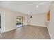 Bright and airy living room with sliding glass doors and stylish light fixtures at 7760 Windbreak Rd, Orlando, FL 32819