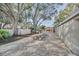 Outdoor recreational area with picnic tables, a tennis court and mature trees creating a relaxing community space at 7760 Windbreak Rd, Orlando, FL 32819