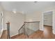Stairway with hardwood floors and iron railing leading to upper level at 7760 Windbreak Rd, Orlando, FL 32819
