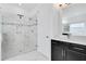Bathroom with shower, quartz vanity, and dark cabinets at 8298 Lookout Pointe Dr, Windermere, FL 34786