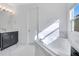 Bathroom boasts a soaking tub and dark vanity at 8298 Lookout Pointe Dr, Windermere, FL 34786