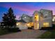 Two story house exterior view at dusk at 8298 Lookout Pointe Dr, Windermere, FL 34786