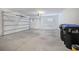 Attached garage with concrete floor and overhead door at 8298 Lookout Pointe Dr, Windermere, FL 34786