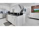 Kitchen island with black countertop and sink at 8298 Lookout Pointe Dr, Windermere, FL 34786