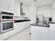 Modern kitchen with white cabinets and double oven at 8298 Lookout Pointe Dr, Windermere, FL 34786