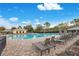 Community pool with lounge chairs and covered seating at 8298 Lookout Pointe Dr, Windermere, FL 34786