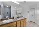Double vanity bathroom with wood cabinets and a large mirror at 9051 Treasure Trove Ln # 301, Kissimmee, FL 34747