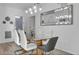 Modern dining room featuring a glass-top table and hardwood floors at 9051 Treasure Trove Ln # 301, Kissimmee, FL 34747