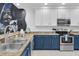 Kitchen with two-toned cabinets and stainless steel appliances at 9051 Treasure Trove Ln # 301, Kissimmee, FL 34747